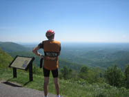 Cyclist admiring view from Rocky Knob overlook.